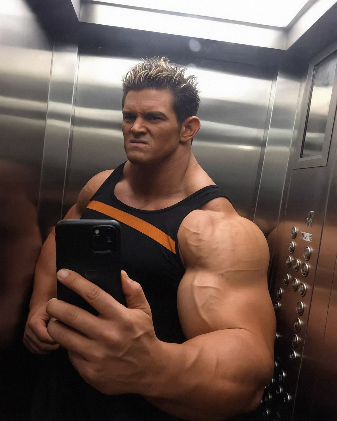 Elon Muskle taking a selfie in a steel elevator, one bicep filling half the frame